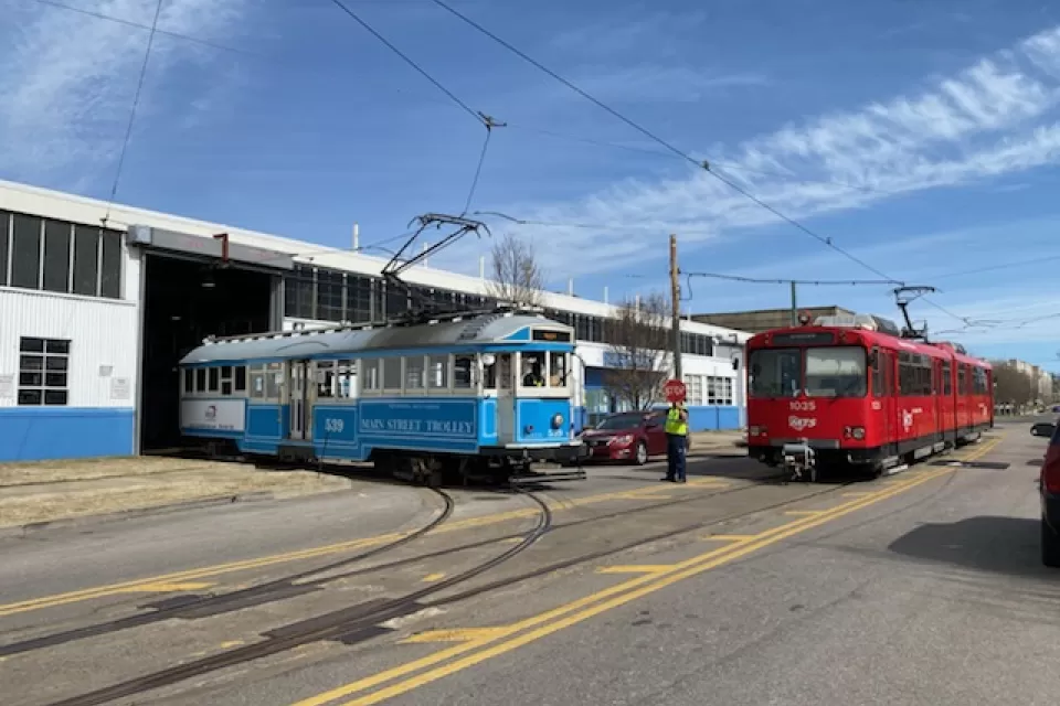 A pair of vintage Siemens–Duewag U2 trolleys roll out of a garage in Memphis.